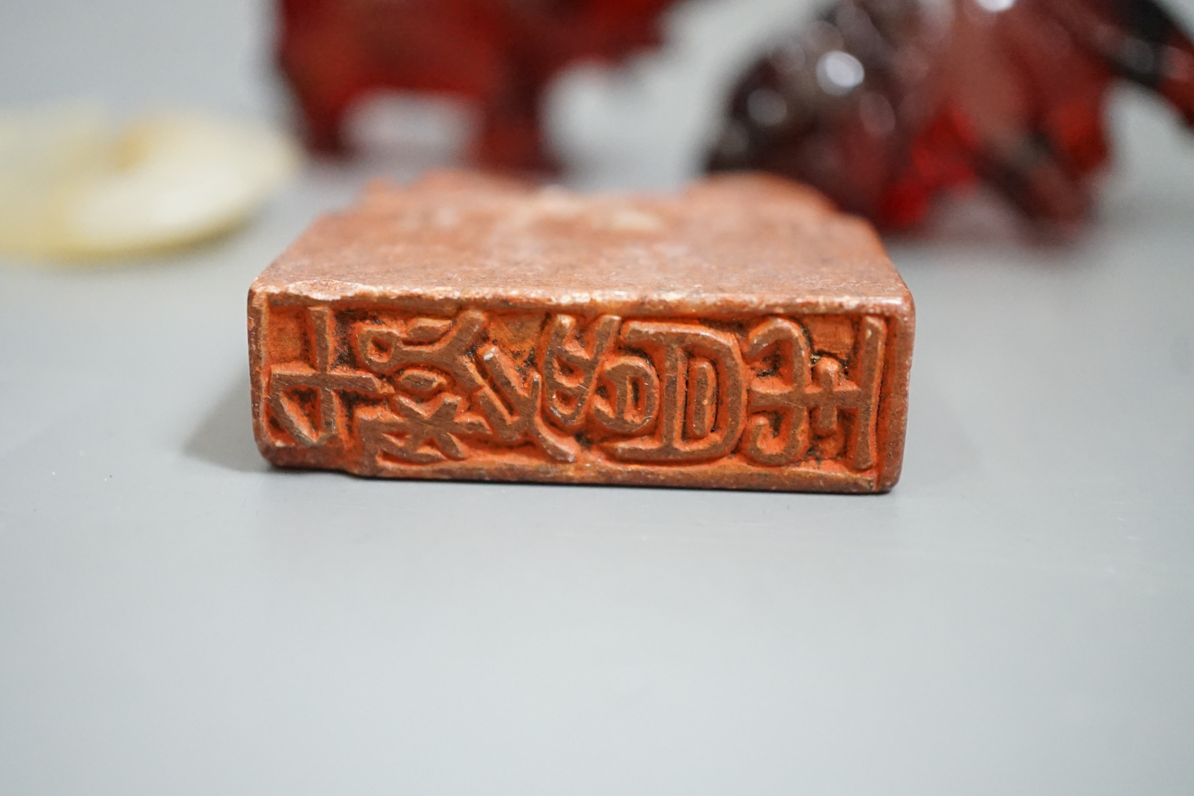 A Chinese Jade bi disc, two cherry amber ox and a soapstone seal